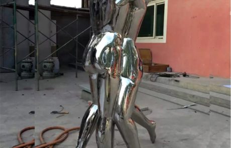 Polished abstract stainless steel figure sculpture