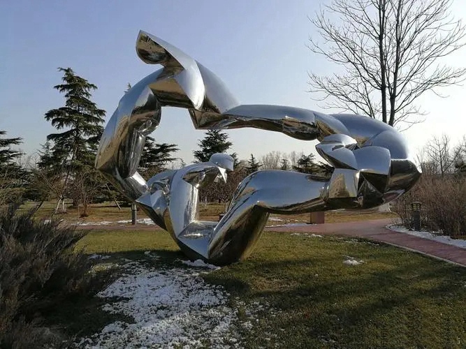polished metal abstract arms sculpture