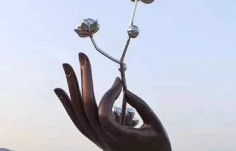 hand holds flower metal sculpture (1)