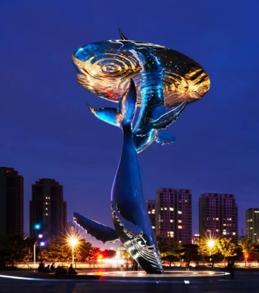whale sculpture at night